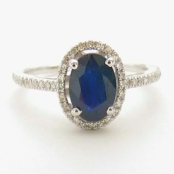 women's engagement rings with stackable design -5X7MM Oval Blue Sapphire and Diamond Halo Ring in 14KT White Gold